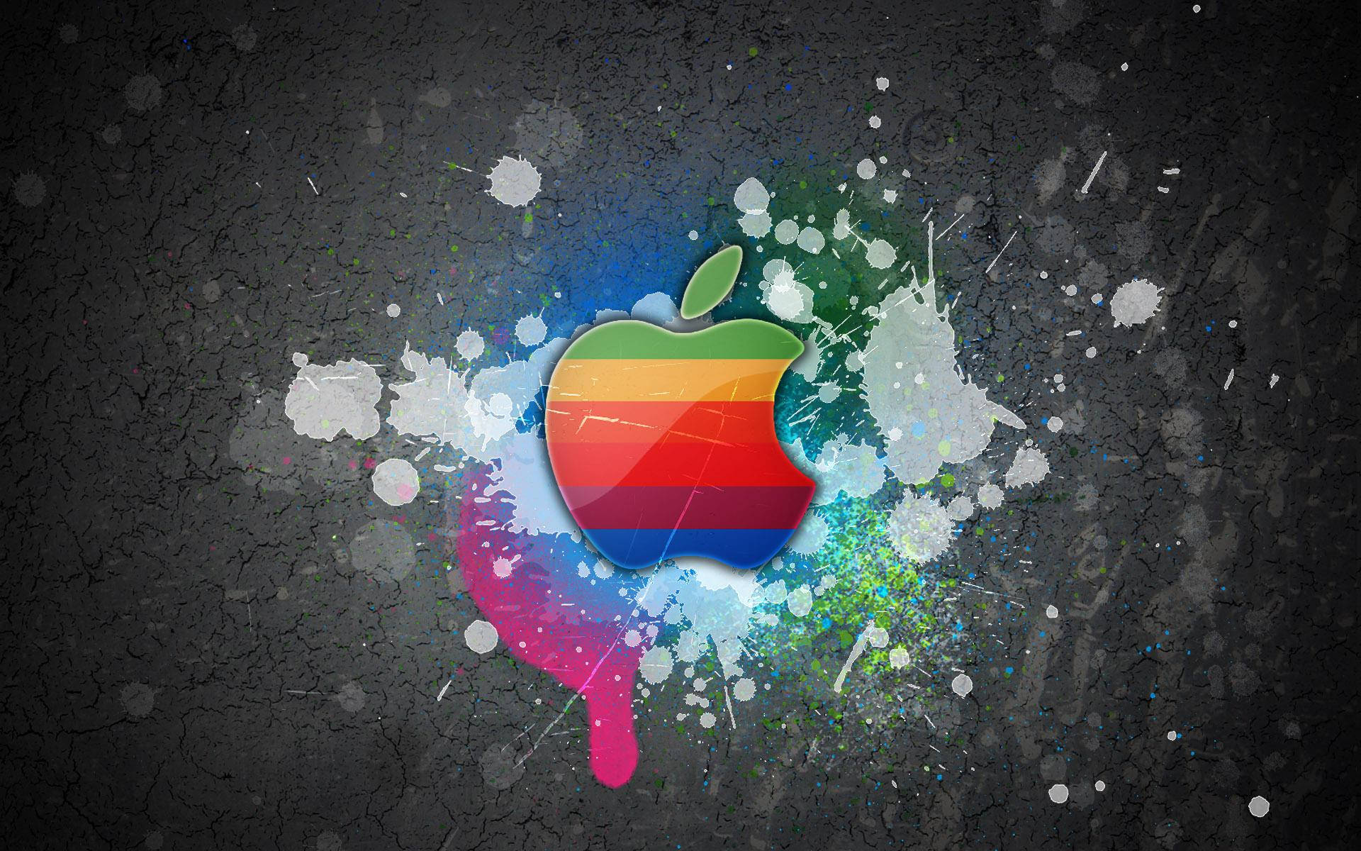 Apple MacBook 標誌的酷炫彩色桌布，灰色牆面帶有油漆潑濺效果